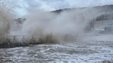 A wave breaks on a sea wall in Weston-super-Mare.