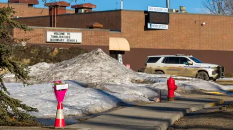 A floral tribute outside Tumbler Ridge Secondary school
