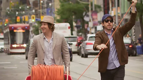 Matt Johnson and Jay McCarrol walking on a street in Nirvanna the Band the Show the Movie (Credit: Elevation Pictures)