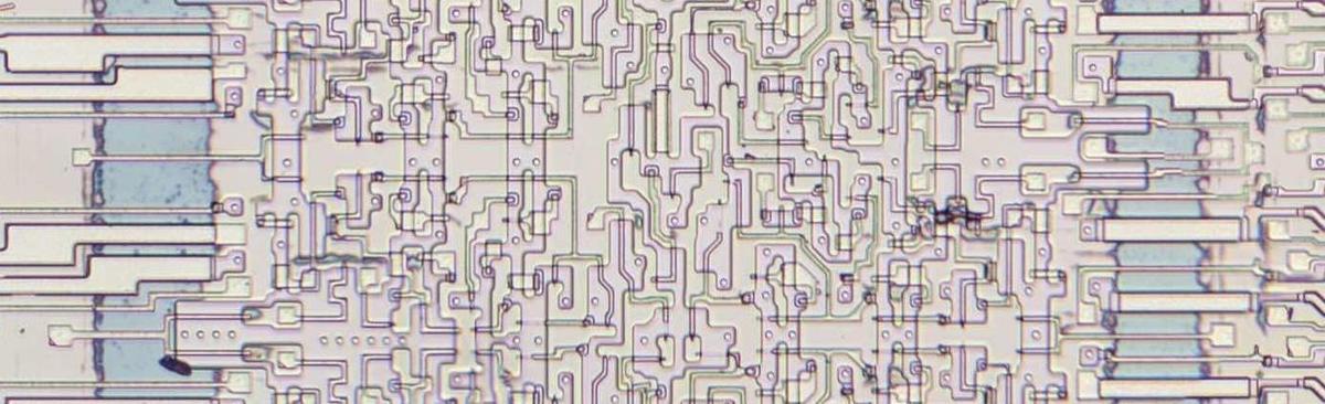 A block of four bits in the adder with the metal layer removed. A block of four bits in the adder with the metal layer removed.